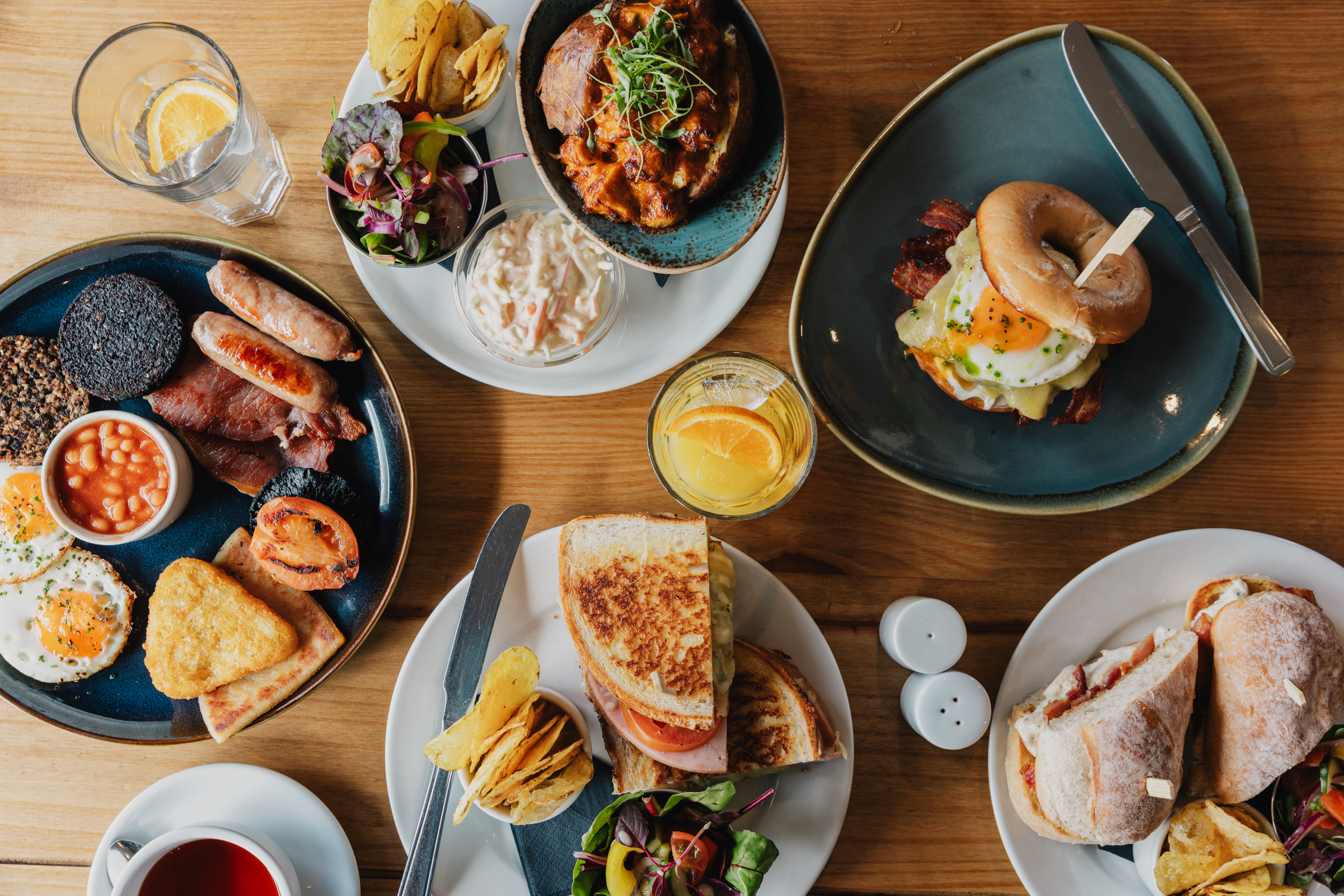 A spread of breakfast and lunch dishes, including a Scottish fry-up and toasted sandwiches, at Willowgate Café near Perth