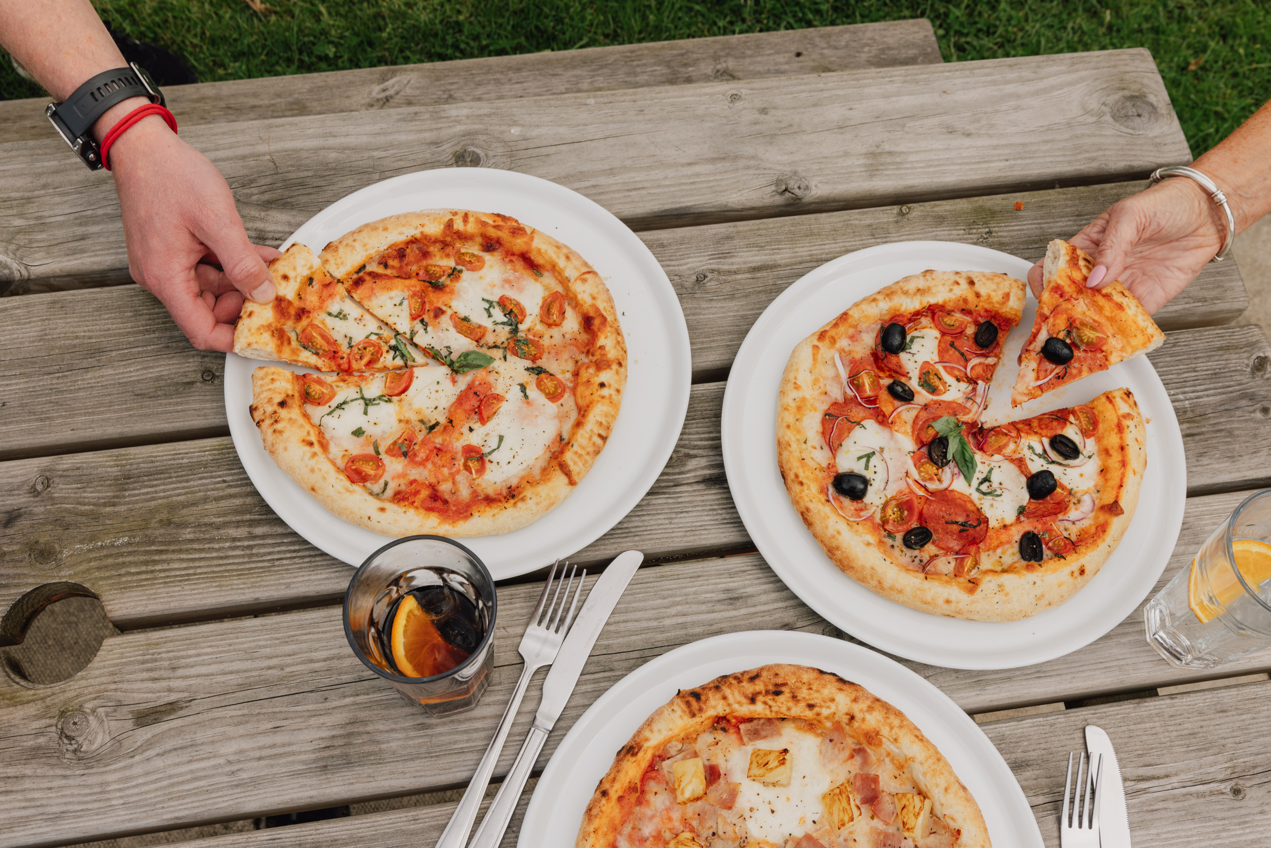 Wood-fired pizzas shared at an outdoor table during Pizza Nights at Willowgate Café near Perth
