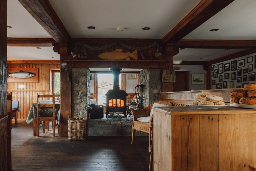 Cosy interior with a lit wood burner and homemade cakes at Willowgate Café, a venue for hire near Perth
