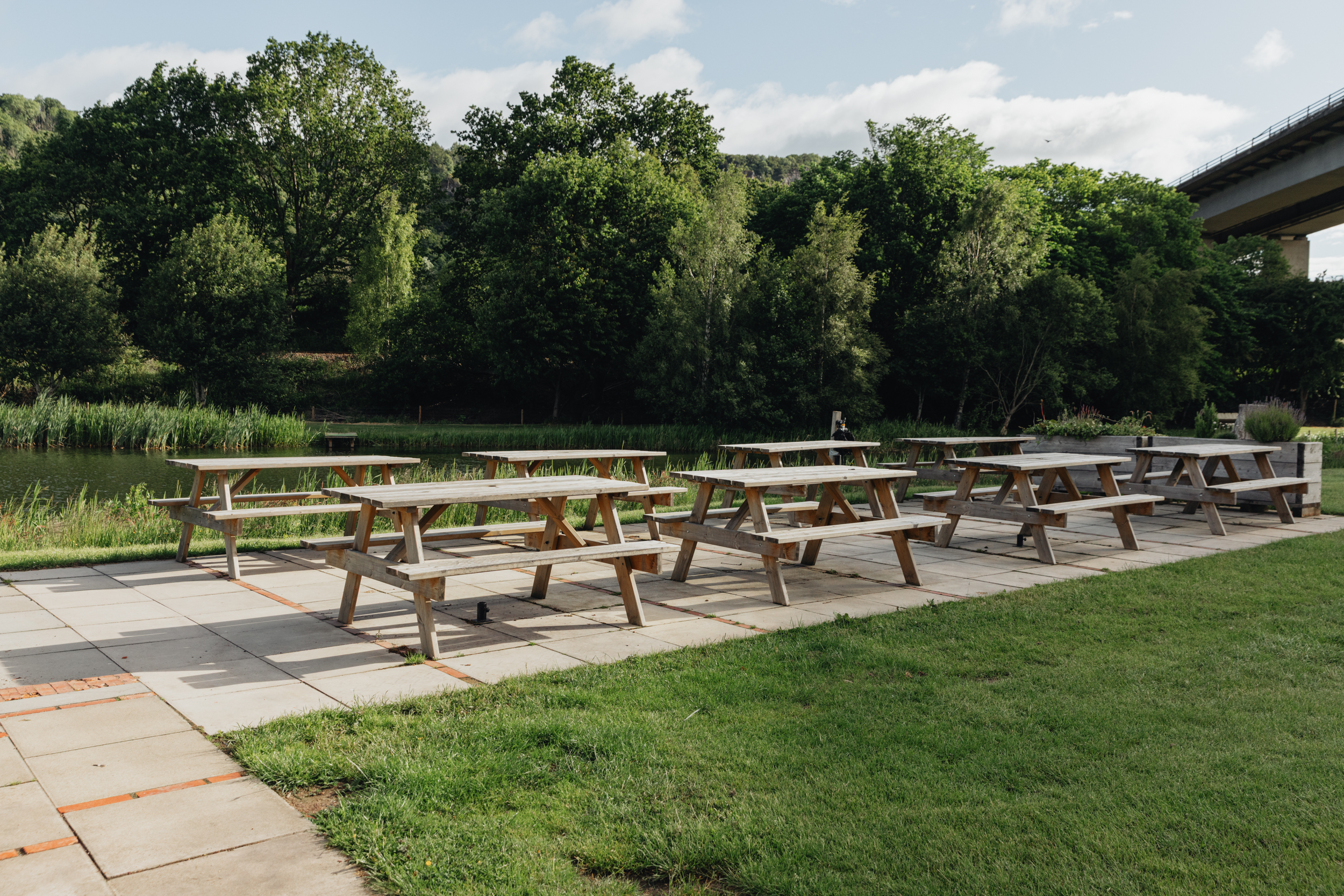 Rows of picnic tables set up outdoors for events at Willowgate Café, available for hire near Perth