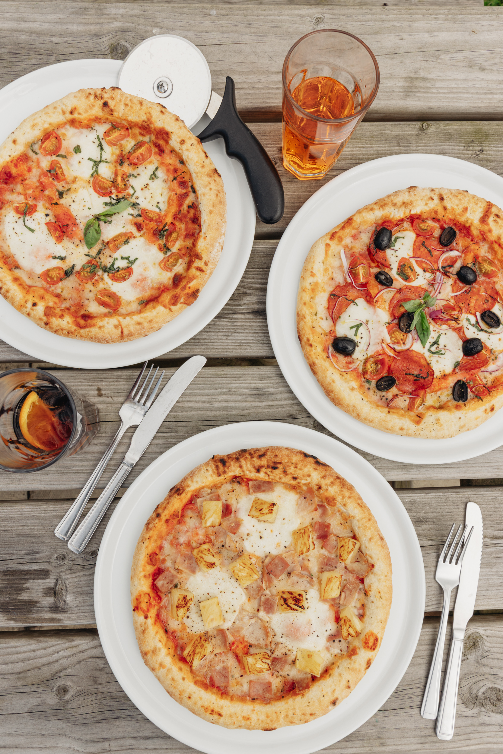 Wood-fired pizzas served on an outdoor table, ideal for catering at Willowgate Café hire events near Perth